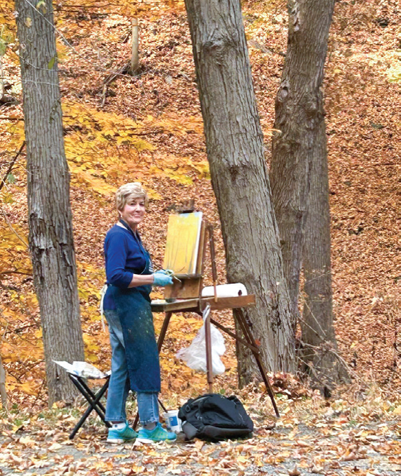 Artist Alice Lieb painting in the woods